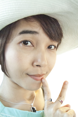 Close up of young asian woman face wear hat show two hand の写真素材