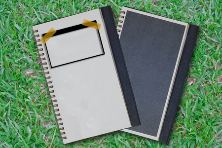 Note book on grass green backgroundの写真素材