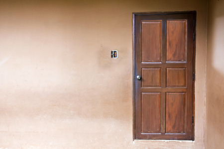 wood door closed on wall の写真素材