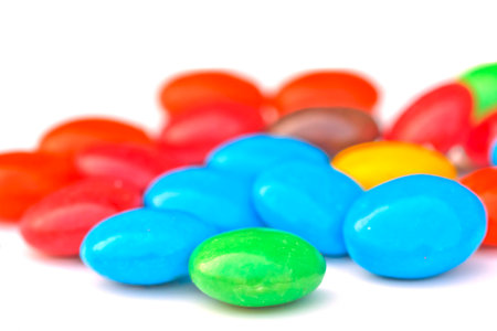 Close up colorful chocolate pills on white background の写真素材