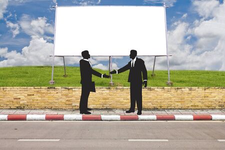 Side road and big white board on grassfield with business man の写真素材