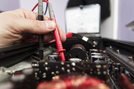 Hands with tech tests electronic equipment in service centerの写真素材
