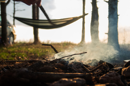 Camping fire with hammock on the background near seaの写真素材