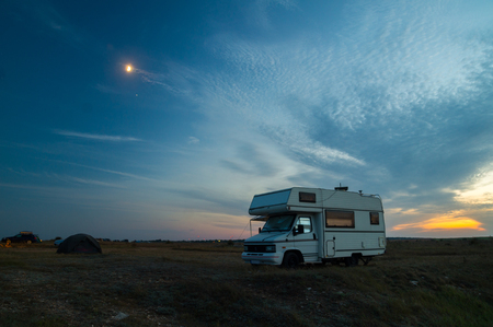Camper van camping with blue hour sunsetの写真素材
