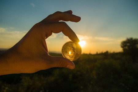 HAND HOLDING BITCOIN CRYPTO CURRENCYの写真素材
