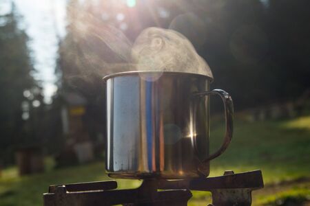 Boiling steaming water in the mountain for tea and coffeeの写真素材