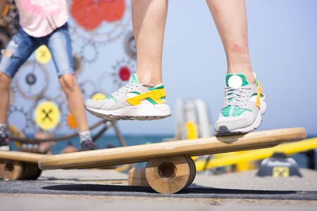 Balancing on a balance board in sunny weather at the beachの写真素材