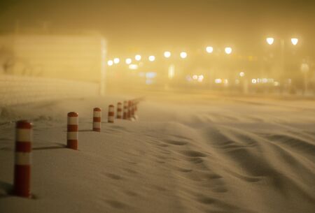 Sandstorm at night covering the road with only traffic cones visible over