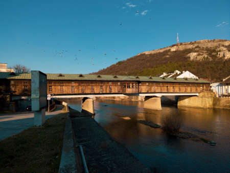 Covered wooden old bridge in traditional town of Bulgaria, Lovech over the Osam River. Build by Nikola Kolio Ficheto Fichev, a famous bulgarian architect, builder and sculptor.のeditorial素材