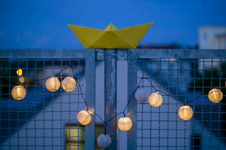 Big yellow paper boat with blue sky and white cloudsの写真素材