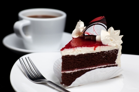 chocolate cake with cherry isolated on black background の写真素材