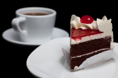 chocolate cake with cherry isolated on black background の写真素材