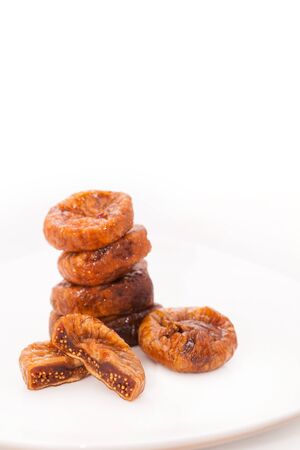 Dried figs on plate isolated in white backgroundの写真素材