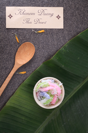 Thai dessert "Khanom Duang" (Sticky Morsels) - Tapioca and rice flour with coconut milk and sugar made into little food colored morsels and sprinkled with shredded coconutの写真素材