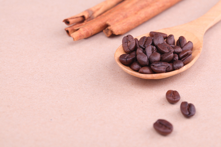 Spread coffee seeds on wooden spoonの写真素材