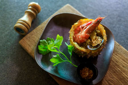 Thai foods : Pineapple Baked Rice This Food delicious  Pineapple Fried Rice with Shrimp Mussels currant and green peas is baked inside a carved pineapple for a unique tropical twist and extra juicy pineapple flavor.の写真素材