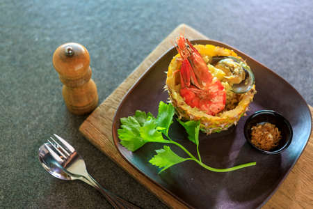 Thai foods : Pineapple Baked Rice This Food delicious  Pineapple Fried Rice with Shrimp Mussels currant and green peas is baked inside a carved pineapple for a unique tropical twist and extra juicy pineapple flavor.の写真素材