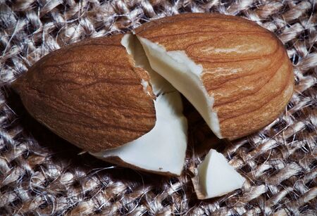 A close up of an almond broken in half.の写真素材