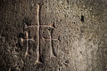 Three crosses carved into the wall of an ancient church in Armeniaの写真素材