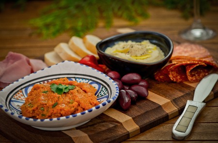 Catering platter with antipasti, dips, bred, meat, cheese and olives