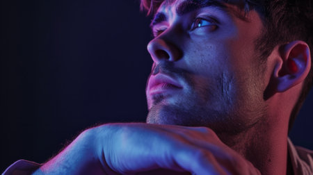 Close-up of a man in a thoughtful pose, in front of a purple studio background generative aiの素材