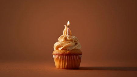 Studio capture of a delicious caramel cupcake topped with a single candle generative aiの素材