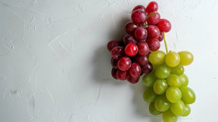 A minimalist composition of red and green grapes on a white background generative aiの素材