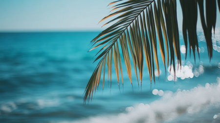 Palm tree branch swaying over a turquoise ocean, tropical beach setting generative aiの素材