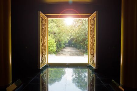 A door opening to shining light and natural view in Wat Nongpahpong, Ubonratchathani, Thailandのeditorial素材