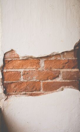 Cracked cement see the inside brick of wall, Vintage style.の写真素材