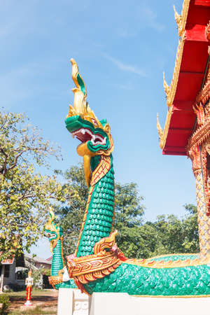 Green Naga statue on the stairs in Buddhist temple.の写真素材