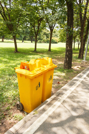 Yellow plastic bin in the public park.の写真素材