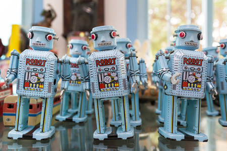 Group of old toy robots with bokeh.
