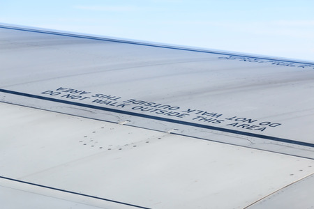 Caution word, Do not walk outside this area on wing of commercial airplane.の写真素材
