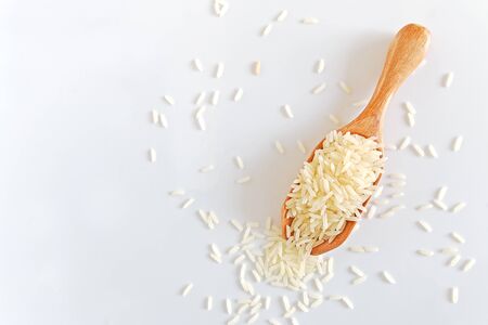 Rice on wooden spoon on white background, isolated.の写真素材