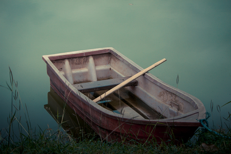 Old plastic boat in scary environment.の写真素材