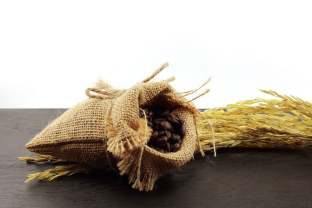 coffee beans in hemp sack bag with rice spikesの写真素材