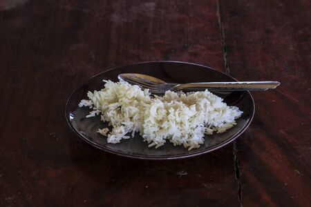 cooked rice in dish on the wooden tableの写真素材
