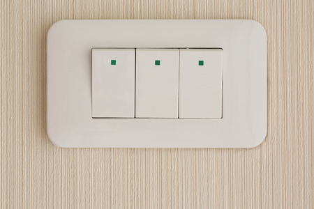 Press turn on/off electrical switch on the wallpaperの写真素材
