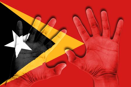 hands on east timor flag backgroundの写真素材
