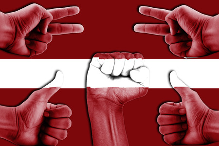 hands on Latvia flag backgroundの写真素材