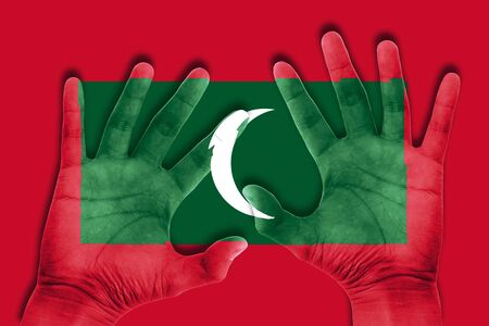 hands on maldives flag backgroundの写真素材