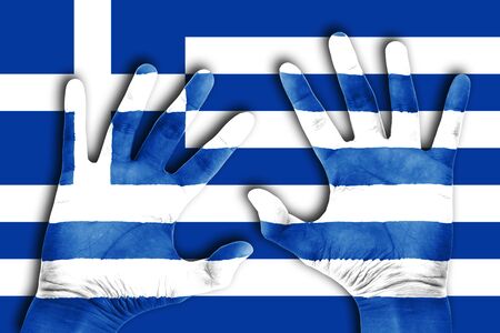 two hand on the greece flag backgroundの写真素材