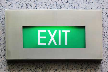 Lighted Wall Mounted Exit Sign Shows People Way Out Public Buildingの写真素材