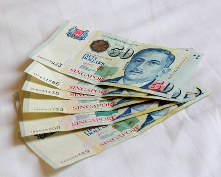 Singapore bank note on the bed sheetの写真素材