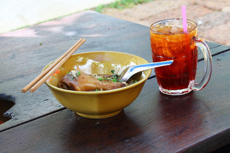 Chicken noodle with ice tea in Thailandの写真素材