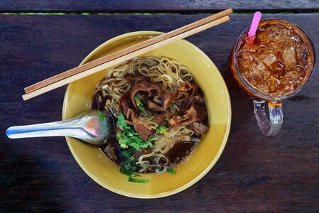 Noodles with pork with soup Thai style and ice tea. Thai peoples call braised pork Noodles or Moo toonの写真素材