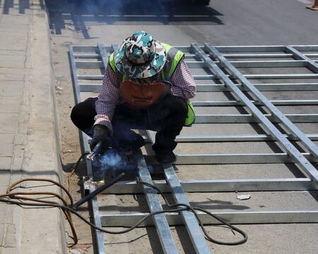 Welding work for steel near footpath areaの写真素材