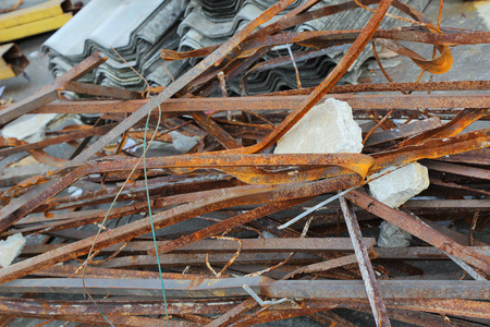Pile of twisted and rusty scrap steel girders being recycled at a building demolition siteの写真素材