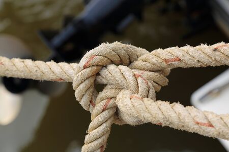 close up of Rope for mooring a boat is adhered to a pierの写真素材